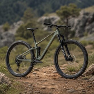 Full-suspension mountain bike on a rocky outdoor trail, showing frame design, suspension structure and off-road tire details.